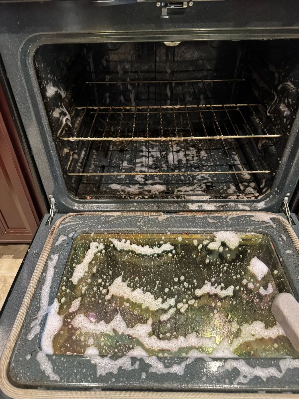 Oven deep cleaning in progress by Royale Cleaning in Richmond, Virginia